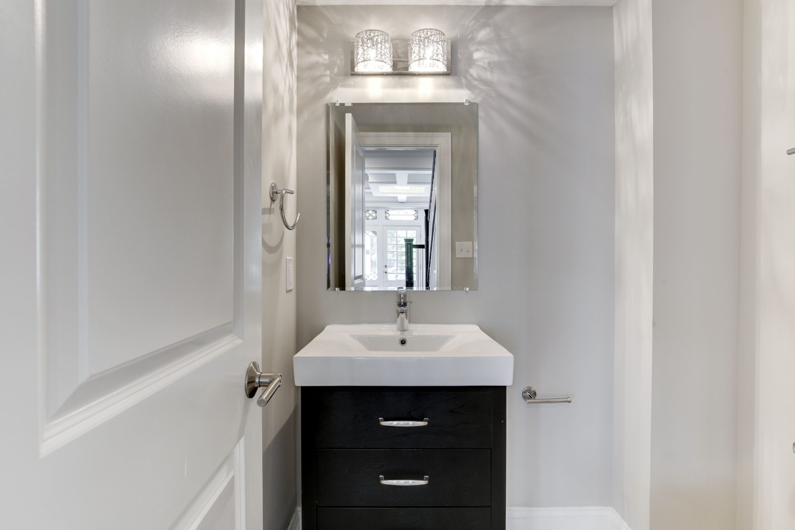 White glam bathroom with brown vanity