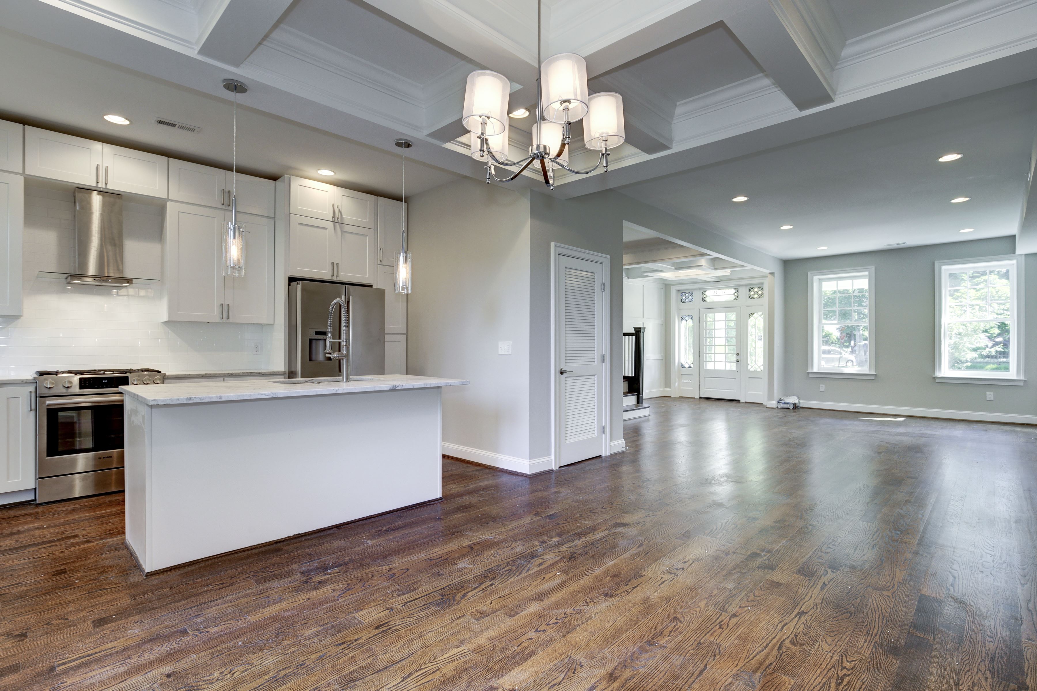 Large white eat-in kitchen with shaker cabinets