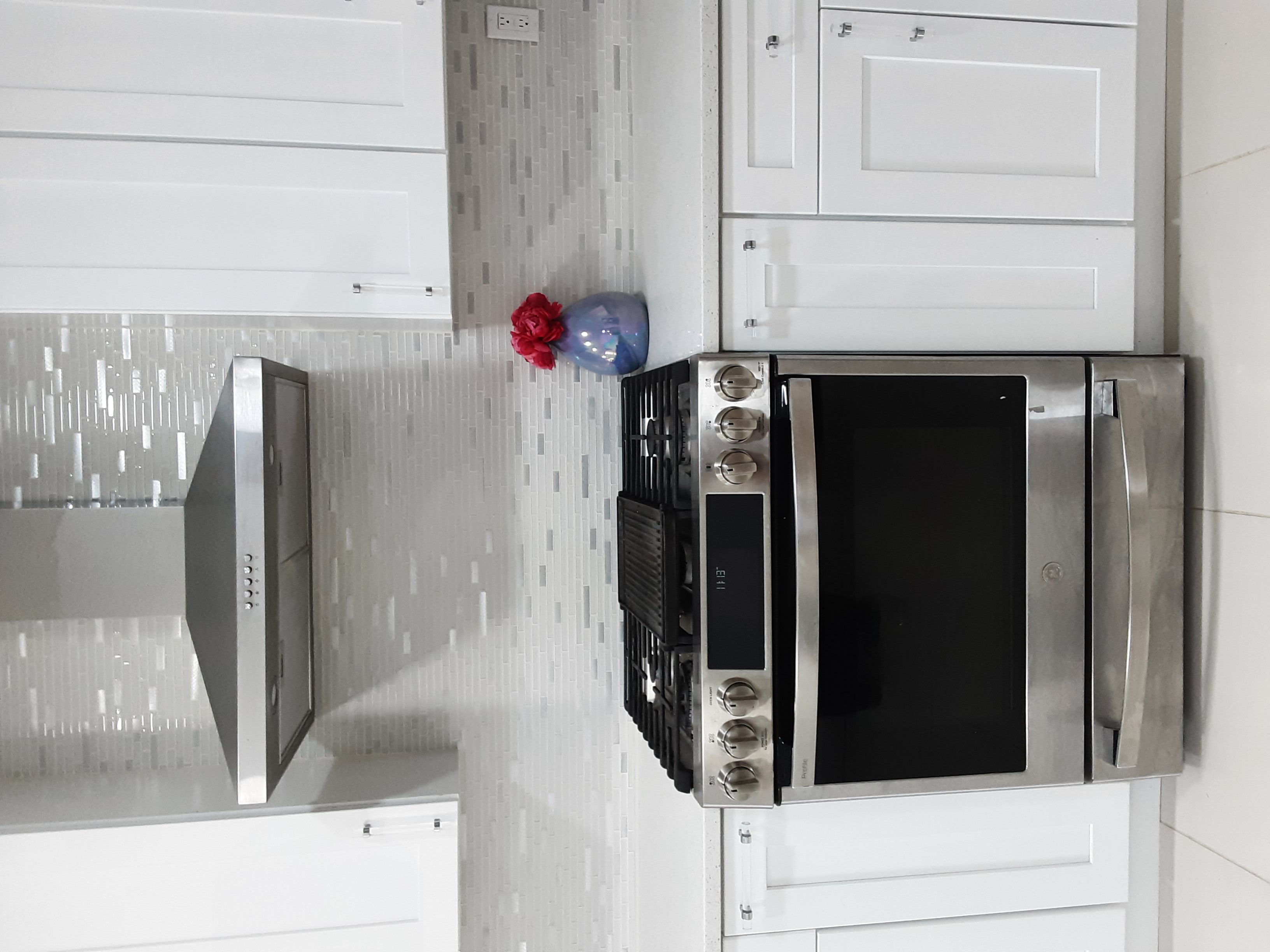 Contemporary white and silver kitchen with stainless steel appliances